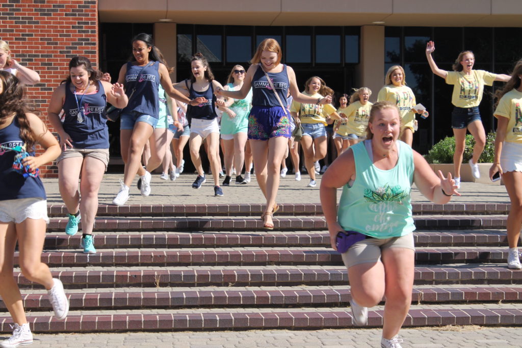 Students rush out of the Tom and Brenda McDaniel University Center to their new sorority sisters during Bid Day on Aug. 21. Photo: Miguel Rios